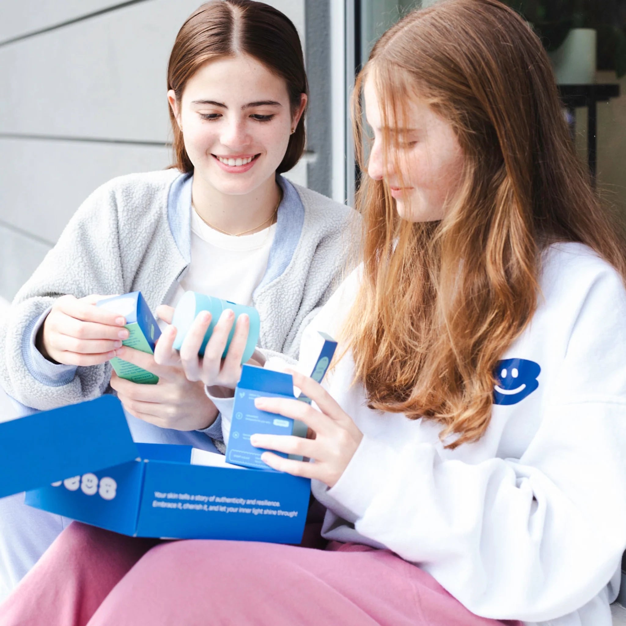 Tween girls unboxing the Daily Glow Bundle for skincare routine.