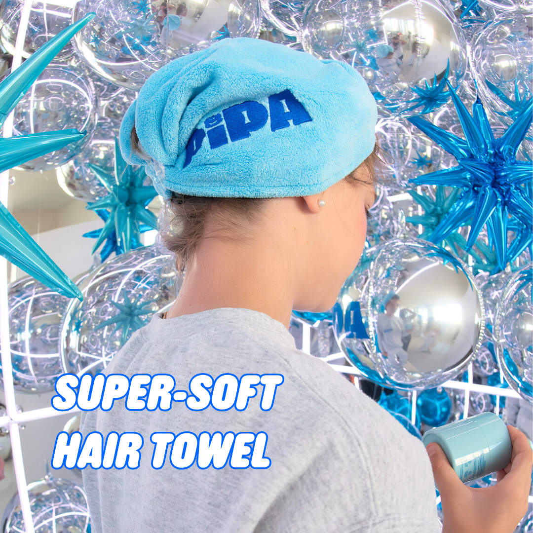 Tween holiday gift super-soft blue hair towel wrapped on girl's head with festive silver and blue decorations background