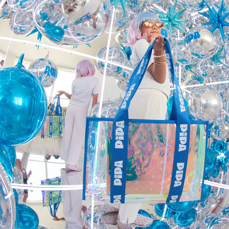 Pipa Blue Bag jelly tote with blue straps in reflective decor setting