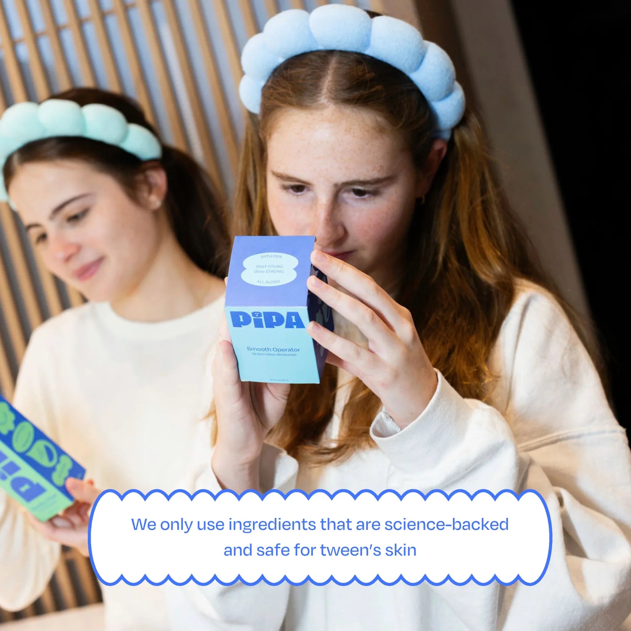 Tween girls examining 'Smooth Operator' facial moisturizer packaging.