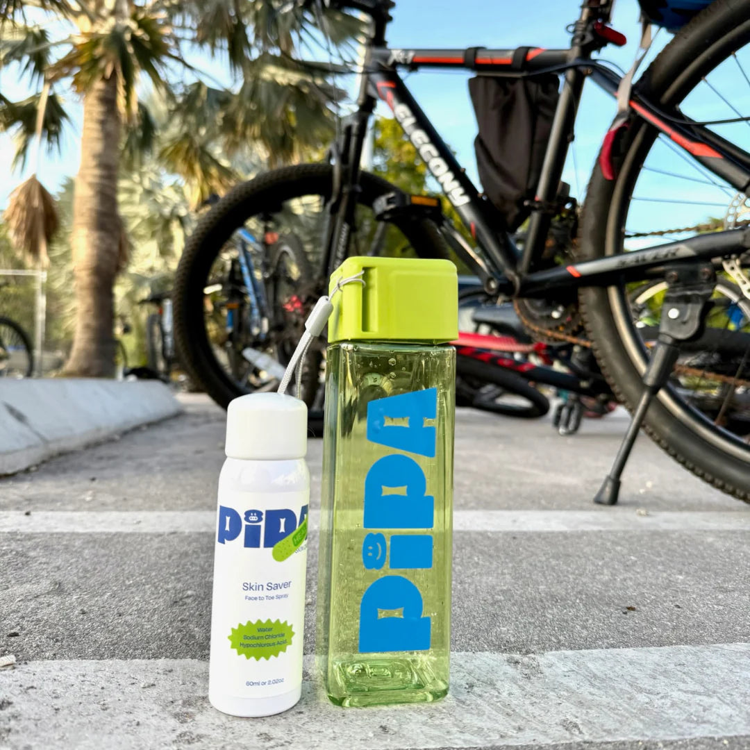 Skin Saver Duo with face and body spray and Pipa water bottle outdoors.